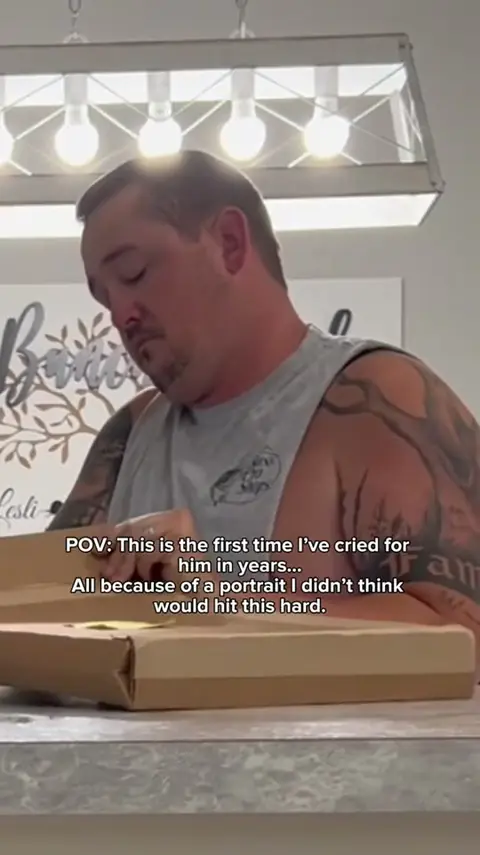 A customer unwrapping their portrait.